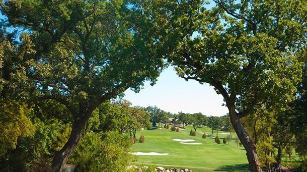 Tree-lined golf hole and sand bunkers at Stevens Park Golf Course in Dallas.